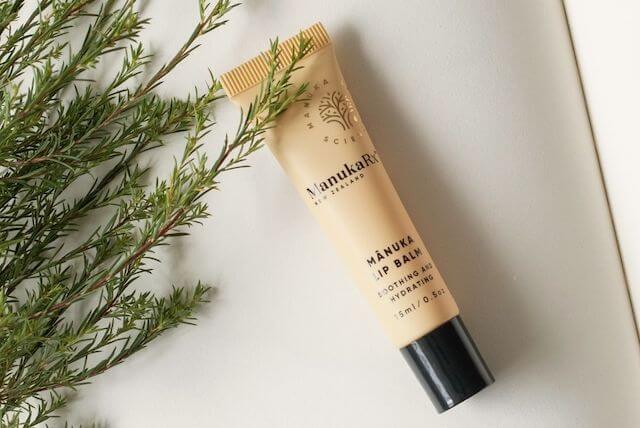 Beeswax Uses - Photo of beeswax and honey spread out on a table with honeycomb.