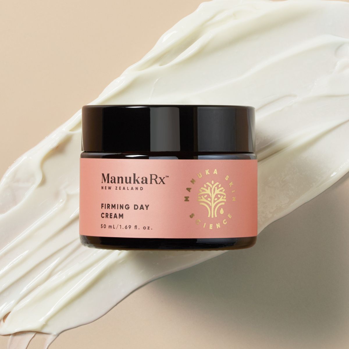 A pot of ManukaRx Firming Day Cream is displayed on a beige background with product swatch