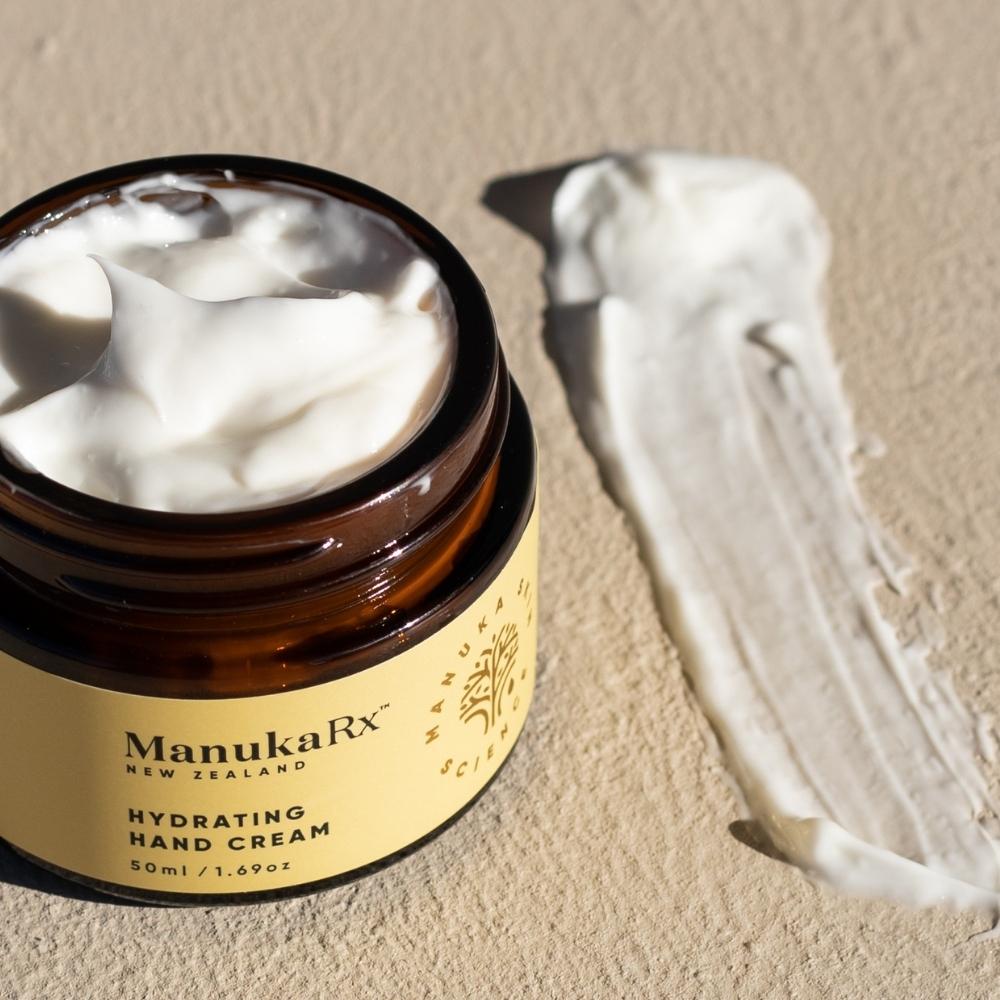 Opened jar of ManukaRx Hydrating Hand Cream with product swatch of hand cream next to it