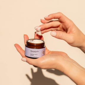 Hands holding a jar of ManukaRx Firming Day Cream