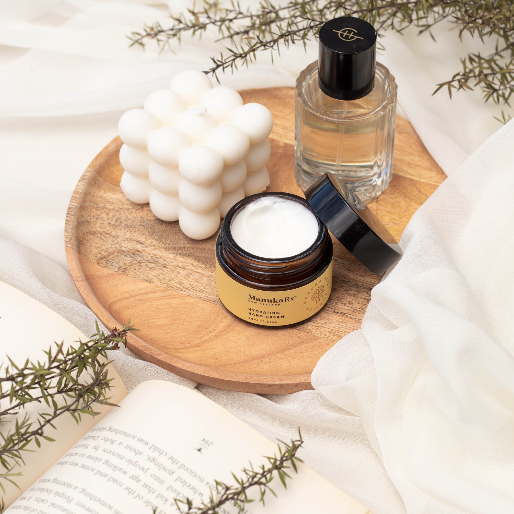 ManukaRx Hydrating Hand Cream jar sitting on wooden tray