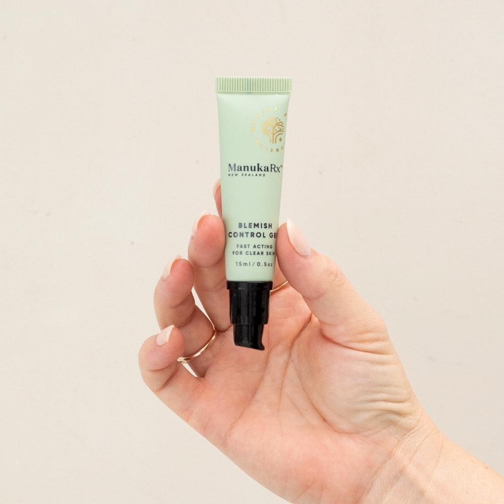 Hand holding a blemish gel that supports the protective skin barrier